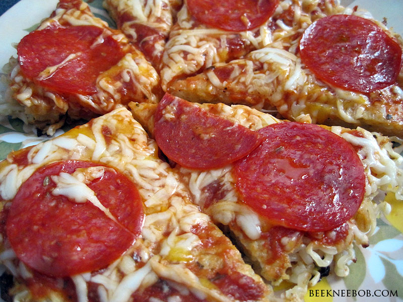a picture of pizza made from Ramen noodles topped with sauce, cheese, and pepperoni