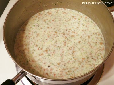 A pot of bacon potato chowder in the middle of the cooking stage