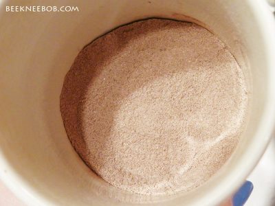 Dry chocolate milk powder at the bottom of a coffee mug